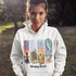 Bring the peaceful charm of Winnipeg Beach with you wherever you go. This soft, comfortable hoodie features a watercolor-style collage celebrating the beauty of Manitoba’s cherished lakeside town.