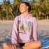 Bring the peaceful charm of Winnipeg Beach with you wherever you go. This soft, comfortable hoodie features a watercolor-style collage celebrating the beauty of Manitoba’s cherished lakeside town.