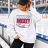 Winnipeg Hockey unisex crewneck sweatshirt featuring vintage navy and red collegiate lettering with a hockey puck graphic, designed by Prairie Life Co.