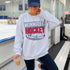 Winnipeg Hockey unisex crewneck sweatshirt featuring vintage navy and red collegiate lettering with a hockey puck graphic, designed by Prairie Life Co.
