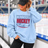 Winnipeg Hockey unisex crewneck sweatshirt featuring vintage navy and red collegiate lettering with a hockey puck graphic, designed by Prairie Life Co.