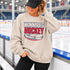 Winnipeg Hockey unisex crewneck sweatshirt featuring vintage navy and red collegiate lettering with a hockey puck graphic, designed by Prairie Life Co.