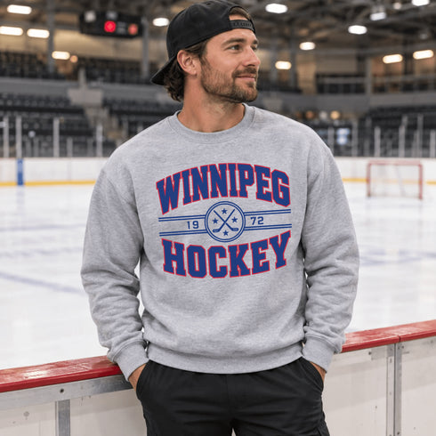 Winnipeg Hockey 1972 vintage-style unisex crewneck sweatshirt with collegiate lettering, crossed hockey sticks and retro hockey graphic by Prairie Life Co.