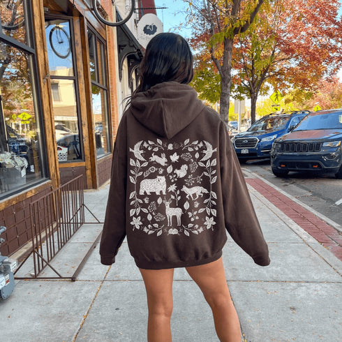 Featuring a collage of woodland animals on the back, this design captures the essence of nature's charm with creatures like foxes, bears and squirrels nestled among lush foliage.