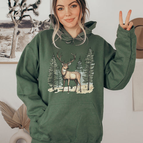 This hoodie features a beautifully crafted design of a majestic deer standing amidst the forest, capturing the quiet elegance of the woods.
