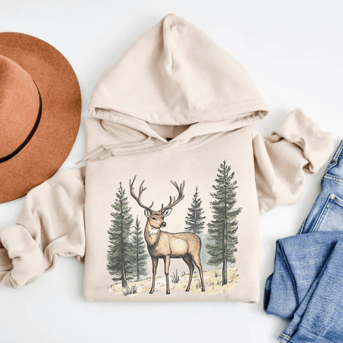This hoodie features a beautifully crafted design of a majestic deer standing amidst the forest, capturing the quiet elegance of the woods.