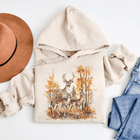 Step into the heart of fall with our Woodland Deer Hoodie, featuring a tender scene of a father deer with his two fawns in a peaceful autumn forest.