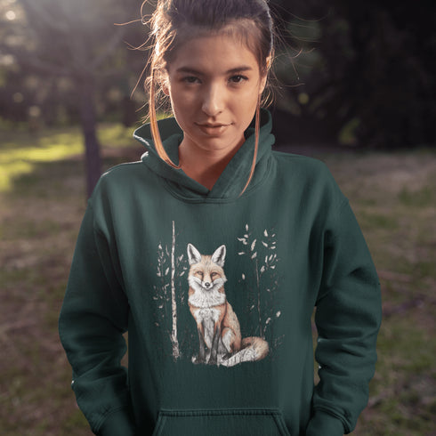 This hoodie features a stunning graphic of a vibrant red fox poised amidst the shadows and light of a lush woodland scene.