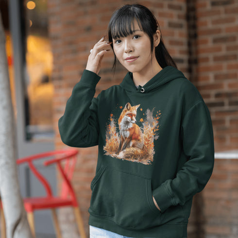 This hoodie features a striking image of a red fox standing alert and proud in its natural habitat, surrounded by lush foliage and the earthy colors of the wilderness.