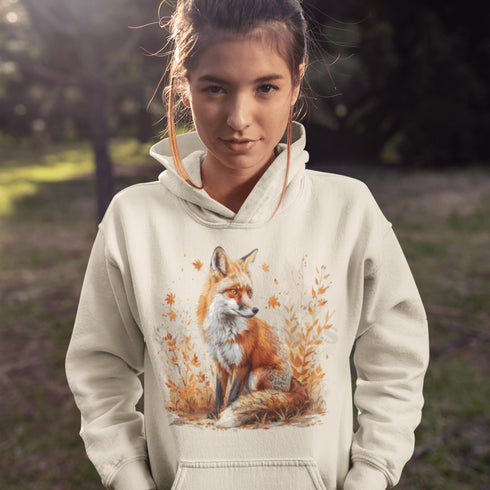 This hoodie features a striking image of a red fox standing alert and proud in its natural habitat, surrounded by lush foliage and the earthy colors of the wilderness.