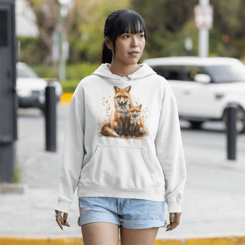 This beautifully crafted hoodie showcases a loving mother fox and her playful kit sitting in a cozy bed of fall foliage, surrounded by vibrant autumn leaves.