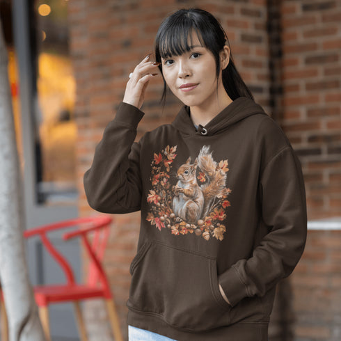 Get ready for fall with the Acorn Gatherer Hoodie, featuring an adorable squirrel surrounded by autumn foliage and a stash of acorns.