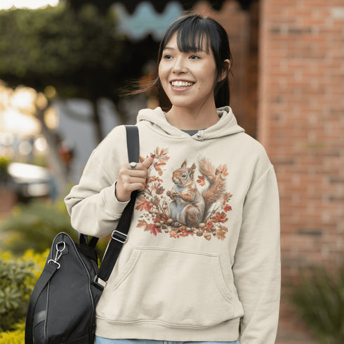 Get ready for fall with the Acorn Gatherer Hoodie, featuring an adorable squirrel surrounded by autumn foliage and a stash of acorns.