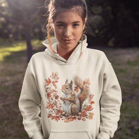 Get ready for fall with the Acorn Gatherer Hoodie, featuring an adorable squirrel surrounded by autumn foliage and a stash of acorns.