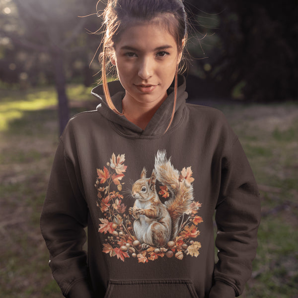Get ready for fall with the Acorn Gatherer Hoodie, featuring an adorable squirrel surrounded by autumn foliage and a stash of acorns.
