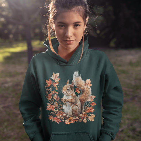 Get ready for fall with the Acorn Gatherer Hoodie, featuring an adorable squirrel surrounded by autumn foliage and a stash of acorns.