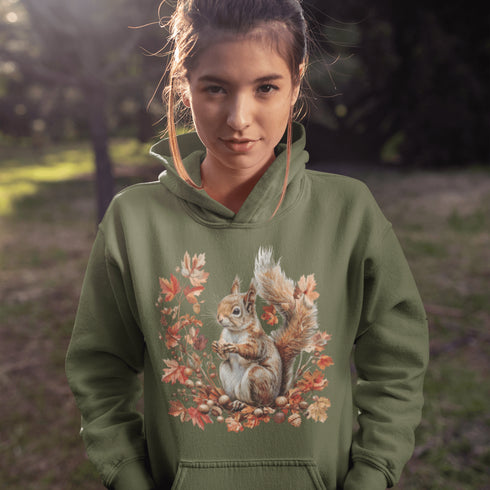 Get ready for fall with the Acorn Gatherer Hoodie, featuring an adorable squirrel surrounded by autumn foliage and a stash of acorns.