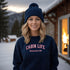 Introducing our customizable gender-neutral sweatshirt, perfect for anyone who loves cabin life and camping!