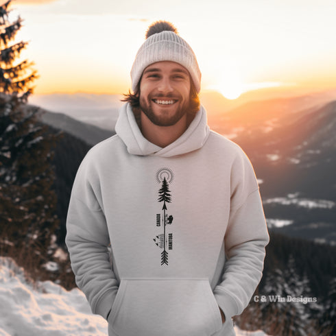 This hoodie features a unique design that showcases the beauty of Manitoba's nature icons, including prairie wheat, geese, bison, a camping scene, trees, and a big sun.