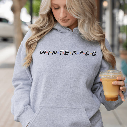 Winnipeg hoodie with Friends font with snow capped lettering and colored snowflakes separating the letters.