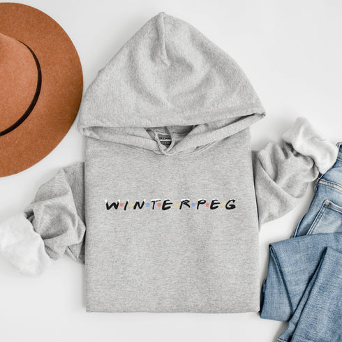 Winnipeg hoodie with Friends font with snow capped lettering and colored snowflakes separating the letters.