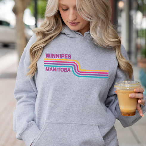 This gender neutral hoodie features a colorful line graphic that pays homage to the vibrant city of Winnipeg, Manitoba.