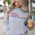 This gender neutral hoodie features a colorful line graphic that pays homage to the vibrant city of Winnipeg, Manitoba.