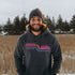 This gender neutral hoodie features A Winnipeg City Skyline and colored retro Stripes across the front.
