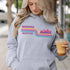 This gender neutral hoodie features A Winnipeg City Skyline and colored retro Stripes across the front.
