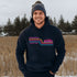 This gender neutral hoodie features A Winnipeg City Skyline and colored retro Stripes across the front.