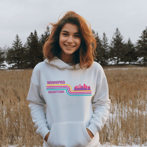 This gender neutral hoodie features A Winnipeg City Skyline and colored retro Stripes across the front.