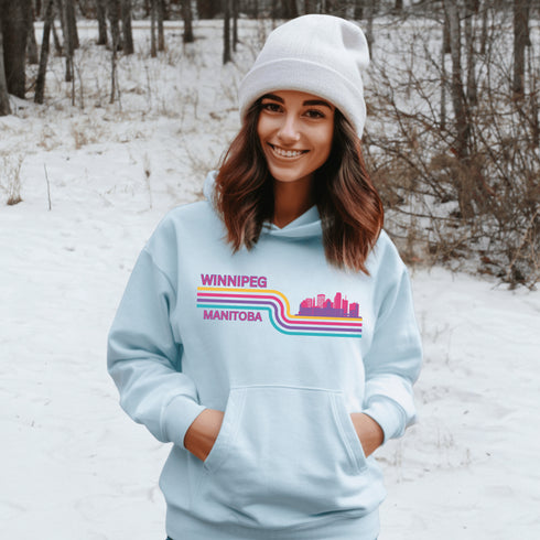 This gender neutral hoodie features A Winnipeg City Skyline and colored retro Stripes across the front.