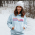 This gender neutral hoodie features A Winnipeg City Skyline and colored retro Stripes across the front.