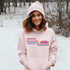 This gender neutral hoodie features A Winnipeg City Skyline and colored retro Stripes across the front.