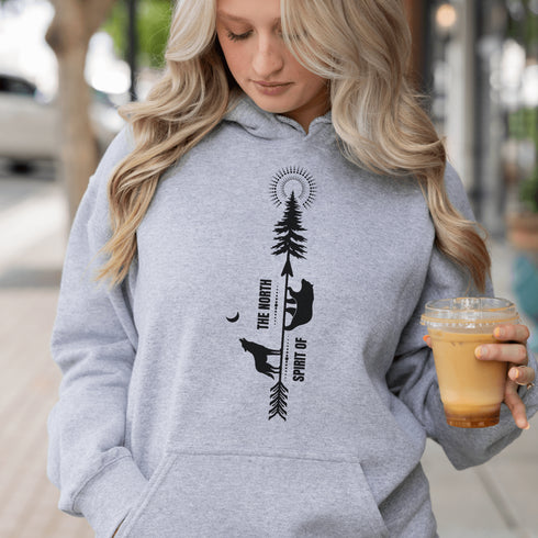 This hoodie features an eye-catching graphic that includes a Polar bear, a Wolf howling at the moon, and a tree with a sun.