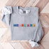 Introducing our newest addition to your wardrobe - the trendy graphic sweatshirt featuring colorful Winnipeg Scrabble Titles.