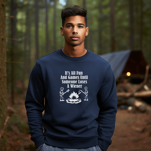 Our Camping sweatshirt features two stick people roasting wieners over a campfire with the hilarious saying, "It's All Fun & Games Until Someone Loses A Wiener."