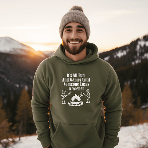 Our Camping hoodie features two adorable stick figure people roasting wieners over a cozy campfire. And with the hilarious slogan "It's All Fun & Games Until Someone Loses A Wiener," you'll be the life of the party at any camping trip!