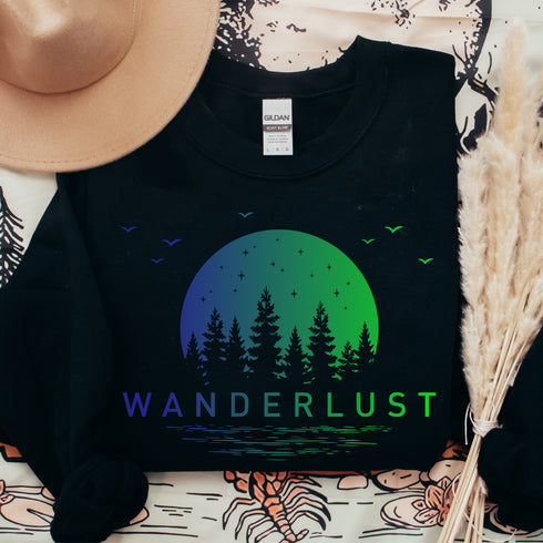 This crewneck features a vibrant and colorful gradient nature scene that will transport you to the great outdoors every time you wear it. The word "Wanderlust" emblazoned across the front serves as a reminder of your passion for exploration and the call of the wild.