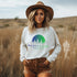 This crewneck features a vibrant and colorful gradient nature scene that will transport you to the great outdoors every time you wear it. The word "Wanderlust" emblazoned across the front serves as a reminder of your passion for exploration and the call of the wild.