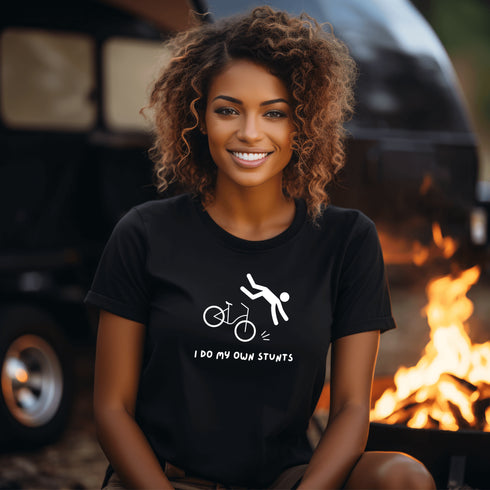 Introducing our latest masterpiece in the world of fashion disasters - the "I Do My Own Stunts" t-shirt! Picture this: a daring stick figure attempting to defy gravity on a bike, only to end up in a spectacular crash landing.