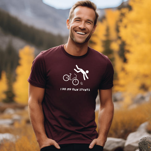 Introducing our latest masterpiece in the world of fashion disasters - the "I Do My Own Stunts" t-shirt! Picture this: a daring stick figure attempting to defy gravity on a bike, only to end up in a spectacular crash landing.