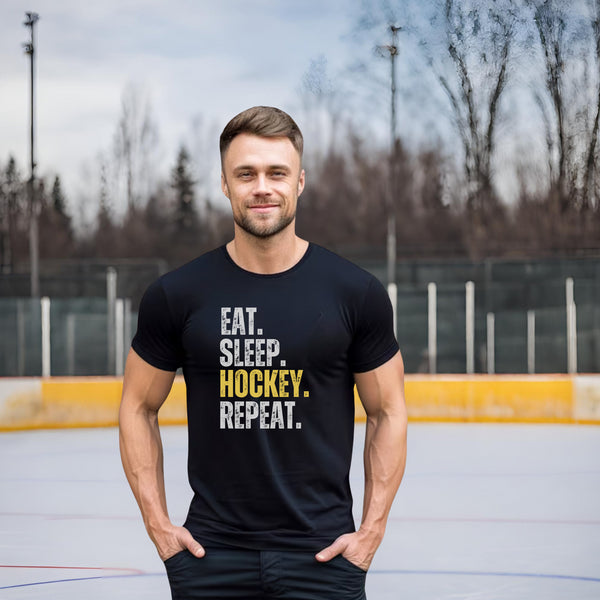 Introducing the ultimate t-shirt for the die-hard hockey fan in your life! This shirt sums up the daily routine of any hockey enthusiast in just four words: "Eat. Sleep. Hockey. Repeat."