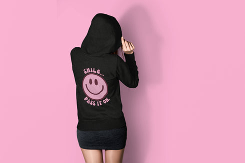 Introducing the latest must-have in your wardrobe that's guaranteed to turn frowns upside down: the Happy Face Hoodie emblazoned with the cheer-spreading command, "Smile...Pass it on." This isn't just any ordinary hoodie; it's your ticket to becoming a walking, talking (and very cozy) ambassador of joy!