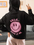Introducing the latest must-have in your wardrobe that's guaranteed to turn frowns upside down: the Happy Face Hoodie emblazoned with the cheer-spreading command, "Smile...Pass it on." This isn't just any ordinary hoodie; it's your ticket to becoming a walking, talking (and very cozy) ambassador of joy!