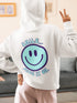 Introducing the latest must-have in your wardrobe that's guaranteed to turn frowns upside down: the Happy Face Hoodie emblazoned with the cheer-spreading command, "Smile...Pass it on." This isn't just any ordinary hoodie; it's your ticket to becoming a walking, talking (and very cozy) ambassador of joy!