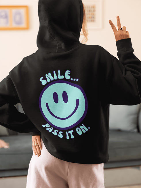 Introducing the latest must-have in your wardrobe that's guaranteed to turn frowns upside down: the Happy Face Hoodie emblazoned with the cheer-spreading command, "Smile...Pass it on." This isn't just any ordinary hoodie; it's your ticket to becoming a walking, talking (and very cozy) ambassador of joy!