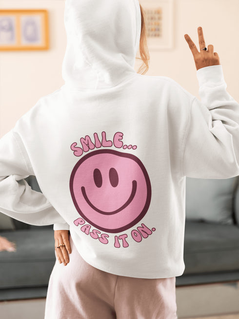 Introducing the latest must-have in your wardrobe that's guaranteed to turn frowns upside down: the Happy Face Hoodie emblazoned with the cheer-spreading command, "Smile...Pass it on." This isn't just any ordinary hoodie; it's your ticket to becoming a walking, talking (and very cozy) ambassador of joy!