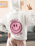 Introducing the latest must-have in your wardrobe that's guaranteed to turn frowns upside down: the Happy Face Hoodie emblazoned with the cheer-spreading command, "Smile...Pass it on." This isn't just any ordinary hoodie; it's your ticket to becoming a walking, talking (and very cozy) ambassador of joy!