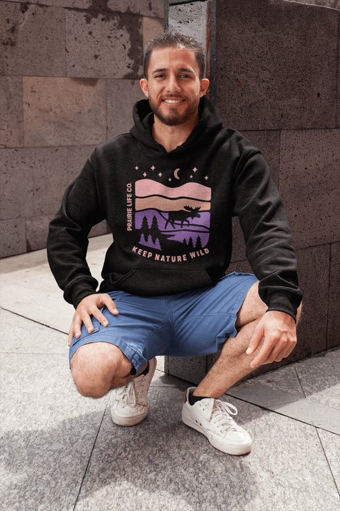 The Keep Nature Wild Hoodie features our signature moose and wilderness design, inspired by the landscapes that make the prairies and beyond so unforgettable.